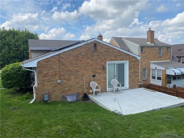 501 Kingsley Ave, Brentwood, PA 15227 - rear view of property with a chimney, a patio, a yard, and brick siding