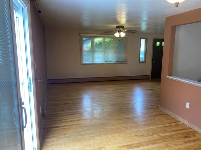 501 Kingsley Ave, Brentwood, PA 15227 - empty room featuring light wood-style flooring, a ceiling fan, a baseboard radiator, and baseboards