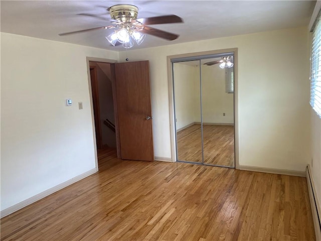 501 Kingsley Ave, Brentwood, PA 15227 - unfurnished bedroom featuring a baseboard radiator, baseboards, light wood-type flooring, and a closet
