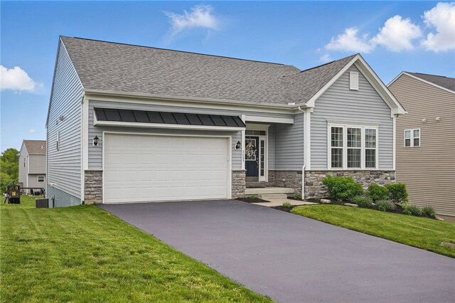 3005 Sir Charles Dr, Cecil, PA 15057 - view of front of house with stone siding, asphalt driveway, roof with shingles, and a front yard
