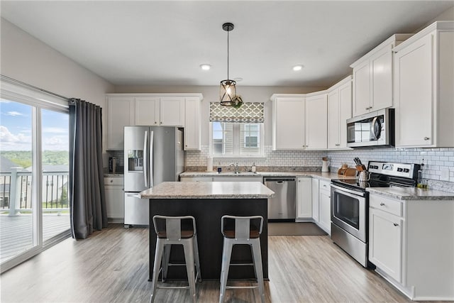 3005 Sir Charles Dr, Cecil, PA 15057 - kitchen with stainless steel appliances, a kitchen island, plenty of natural light, tasteful backsplash, and recessed lighting