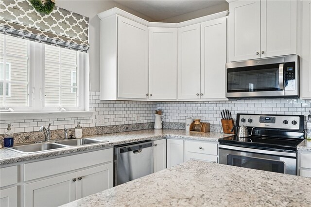 3005 Sir Charles Dr, Cecil, PA 15057 - kitchen featuring stainless steel appliances, a sink, white cabinetry, decorative backsplash, and plenty of natural light