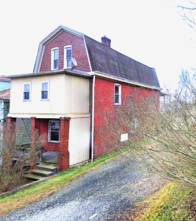 619 Dawson St, Wall Boro, PA 15148 - view of side of property featuring brick siding, a chimney, and a gambrel roof