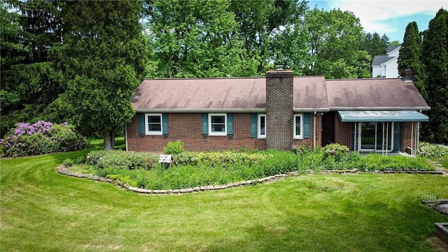 135 N Benbrook Rd, Center Twp But, PA 16001 - single story home with brick siding, a front yard, and a chimney