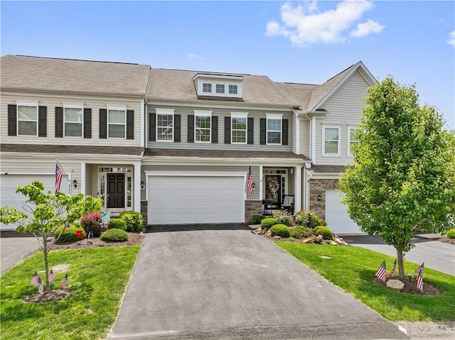 2282 Flint Dr, South Strabane, PA 15301 - view of property featuring an attached garage, asphalt driveway, a front lawn, and stone siding