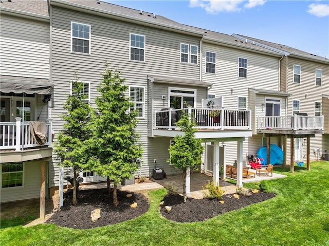 2282 Flint Dr, South Strabane, PA 15301 - back of property with a patio, a lawn, central AC, and a wooden deck