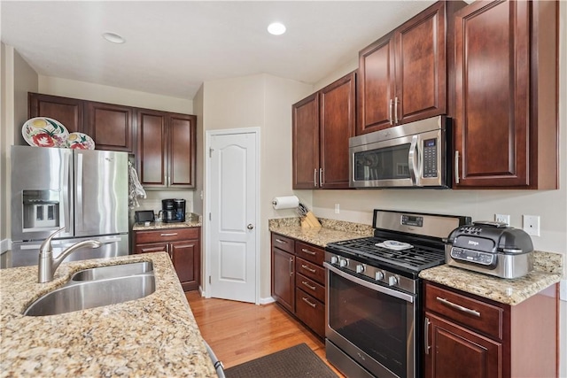 2282 Flint Dr, South Strabane, PA 15301 - kitchen featuring appliances with stainless steel finishes, a sink, light wood-style floors, light stone counters, and recessed lighting