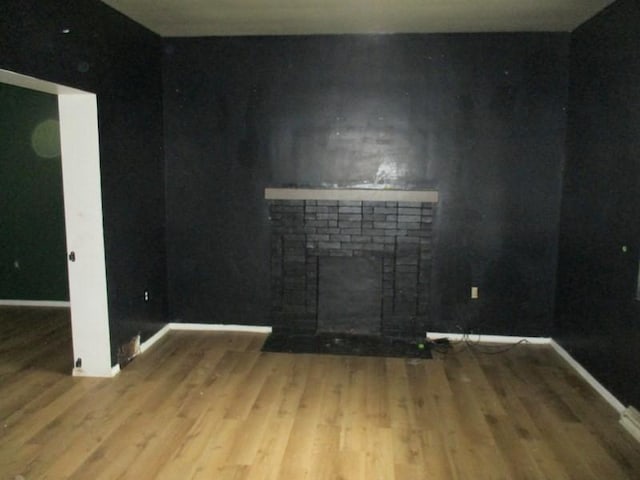 1528 Beaver Rd, Ambridge, PA 15003 - unfurnished living room with wood finished floors, a brick fireplace, and baseboards