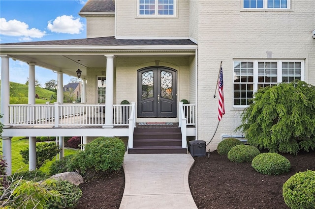 506 Villa Dr, Peters Twp, PA 15367 - doorway to property featuring a porch, brick siding, a shingled roof, and french doors