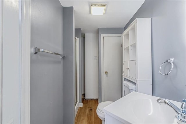 5 Rio Vista St, West Newton, PA 15089 - bathroom featuring a sink, wood finished floors, a stall shower, toilet, and baseboards