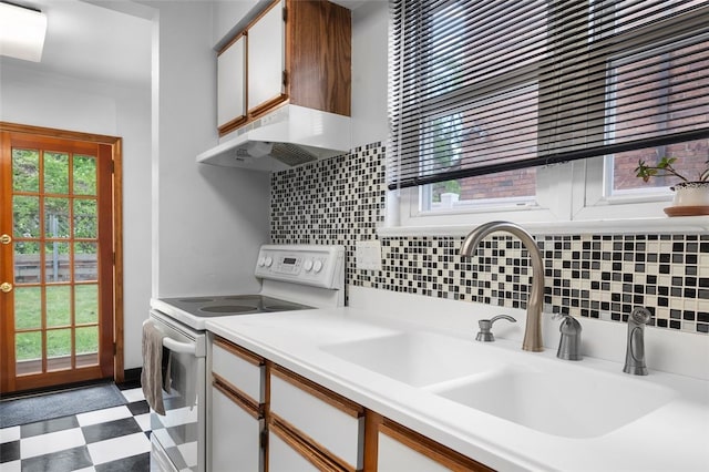 3983 Beechwood Blvd, Squirrel Hill, PA 15217 - kitchen with white range with electric stovetop, a sink, light floors, under cabinet range hood, and backsplash