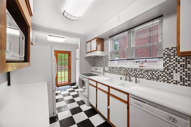 3983 Beechwood Blvd, Squirrel Hill, PA 15217 - kitchen with white appliances, a sink, dark flooring, light countertops, and decorative backsplash