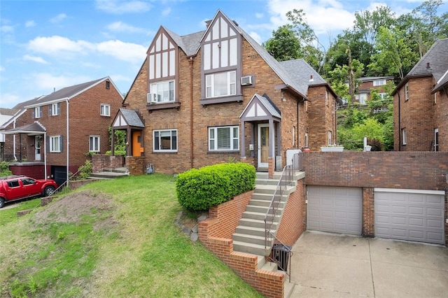 3983 Beechwood Blvd, Squirrel Hill, PA 15217 - tudor house with a front lawn, brick siding, concrete driveway, and a garage