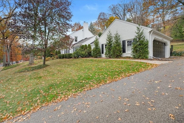 22 Woodland Rd, Edgeworth, PA 15143 - view of side of property featuring an attached garage, a yard, driveway, and a chimney