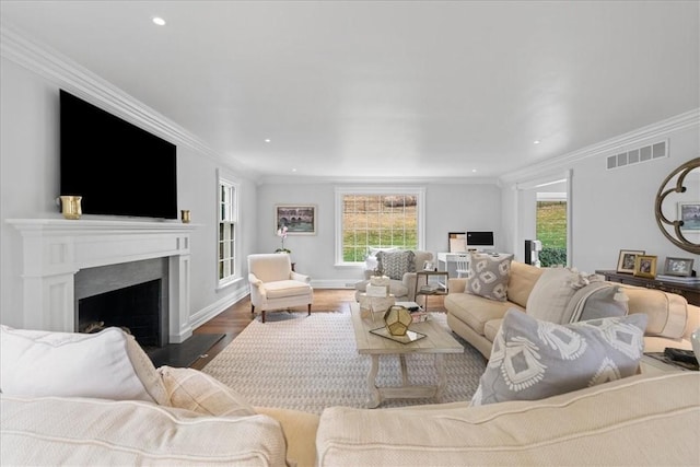 22 Woodland Rd, Edgeworth, PA 15143 - living area with healthy amount of natural light, a fireplace, wood finished floors, ornamental molding, and recessed lighting