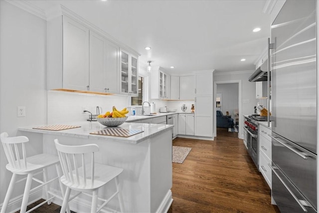 22 Woodland Rd, Edgeworth, PA 15143 - kitchen featuring high quality appliances, a sink, white cabinets, glass insert cabinets, and a peninsula