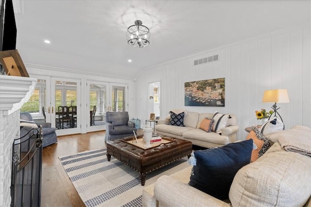 22 Woodland Rd, Edgeworth, PA 15143 - living room featuring healthy amount of natural light, wood finished floors, crown molding, french doors, and a chandelier