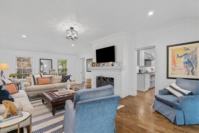 22 Woodland Rd, Edgeworth, PA 15143 - living room with a fireplace, ornamental molding, wood finished floors, vaulted ceiling, and a chandelier