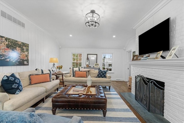 22 Woodland Rd, Edgeworth, PA 15143 - living room featuring wood finished floors, ornamental molding, a chandelier, a brick fireplace, and recessed lighting