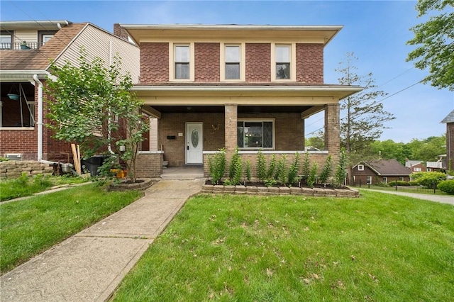 121 N Lehigh St, Munhall, PA 15120 - american foursquare style home with brick siding, a front lawn, and covered porch