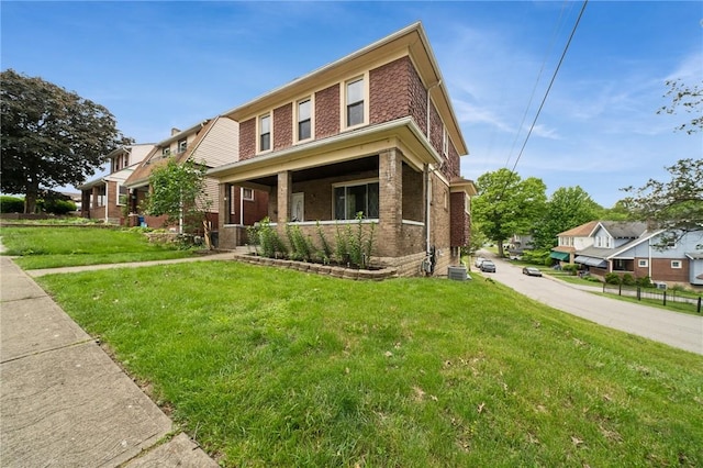 121 N Lehigh St, Munhall, PA 15120 - view of front of house featuring brick siding, a front lawn, and covered porch
