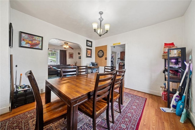 121 N Lehigh St, Munhall, PA 15120 - dining area featuring arched walkways, a chandelier, and light wood-type flooring