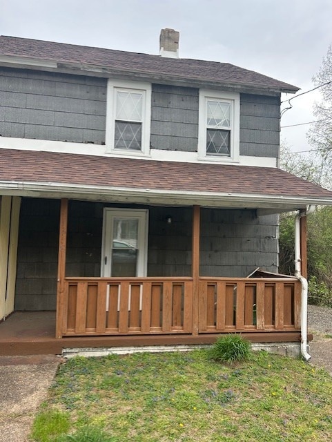 1318 Macarthur Dr, West Deer, PA 15076 - view of front facade featuring covered porch, a shingled roof, and a chimney