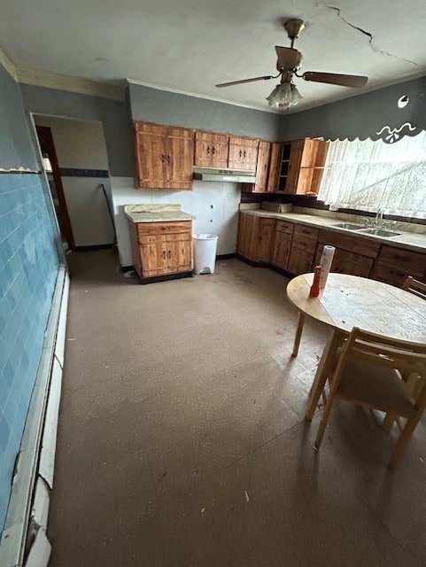 1318 Macarthur Dr, West Deer, PA 15076 - kitchen featuring a sink, a ceiling fan, brown cabinetry, light countertops, and under cabinet range hood