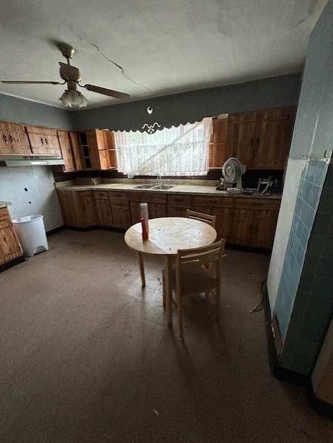 1318 Macarthur Dr, West Deer, PA 15076 - kitchen with a sink, brown cabinets, under cabinet range hood, and a ceiling fan