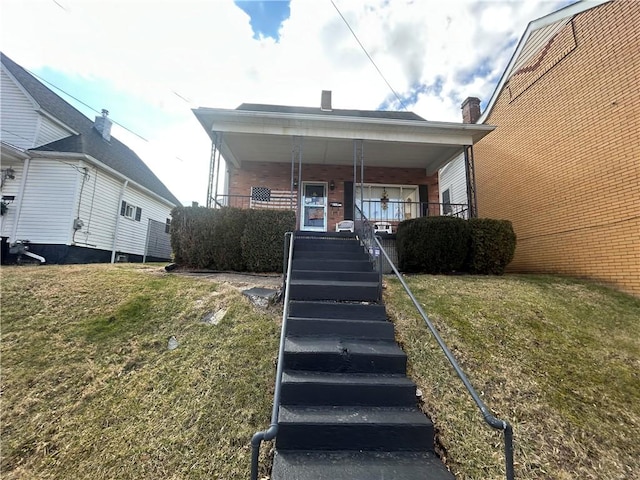 217 Meadow Ave, Charleroi Boro, PA 15022 - view of front of house featuring stairway, a porch, and a front yard