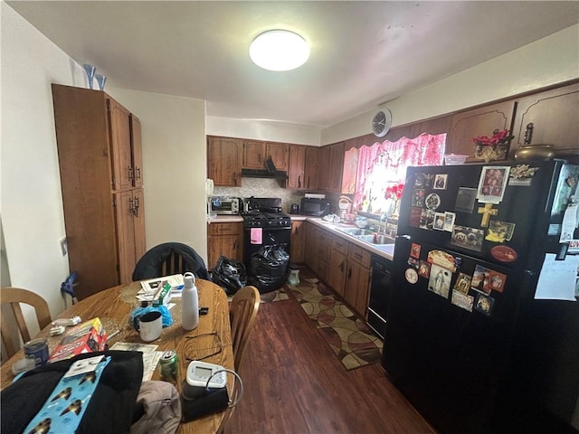 217 Meadow Ave, Charleroi Boro, PA 15022 - kitchen with black appliances, dark wood-style flooring, light countertops, under cabinet range hood, and a sink