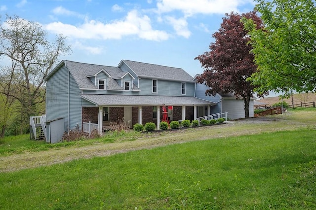 146 Peters Ln, Winfield Twp, PA 16023 - view of front facade featuring a front lawn, a porch, roof with shingles, and brick siding