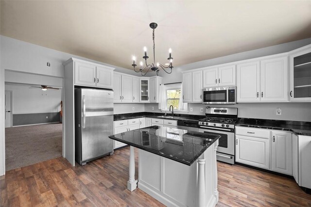 146 Peters Ln, Winfield Twp, PA 16023 - kitchen with stainless steel appliances, a sink, a chandelier, white cabinets, and a kitchen island