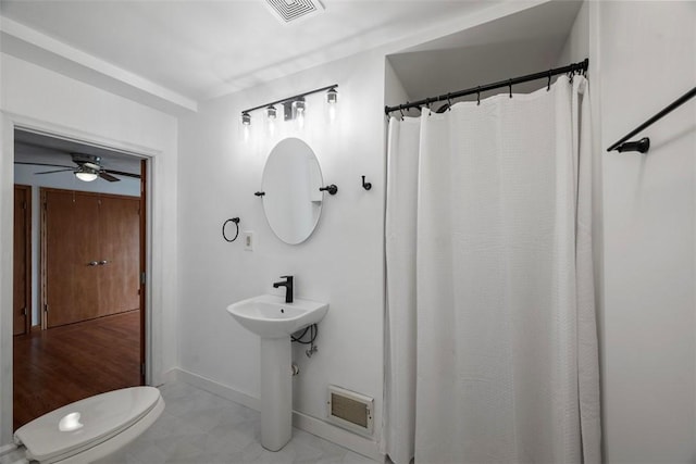 146 Peters Ln, Winfield Twp, PA 16023 - bathroom with baseboards, toilet, ceiling fan, and a shower with shower curtain