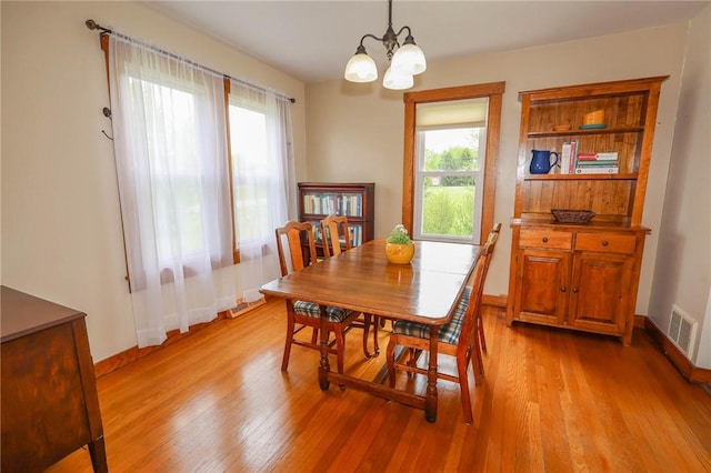 1265 Slippery Rock Rd, Liberty Twp, PA 16057 - dining room with light wood-type flooring, a chandelier, and baseboards