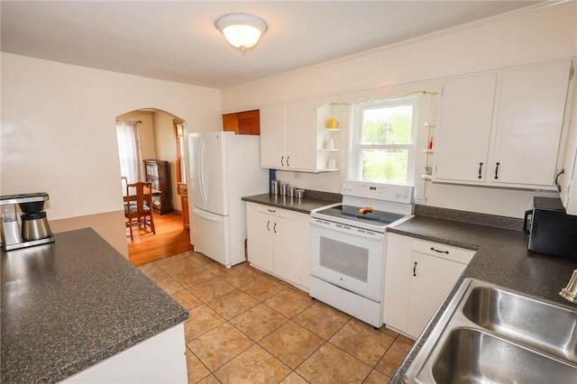 1265 Slippery Rock Rd, Liberty Twp, PA 16057 - kitchen featuring white appliances, arched walkways, open shelves, and dark countertops