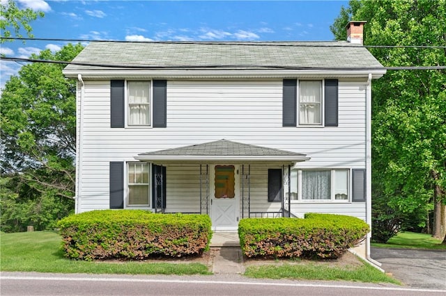 2265 State Route 982, Mount Pleasant Twp Wml, PA 15666 - view of front facade featuring a chimney, a porch, a front yard, and a shingled roof