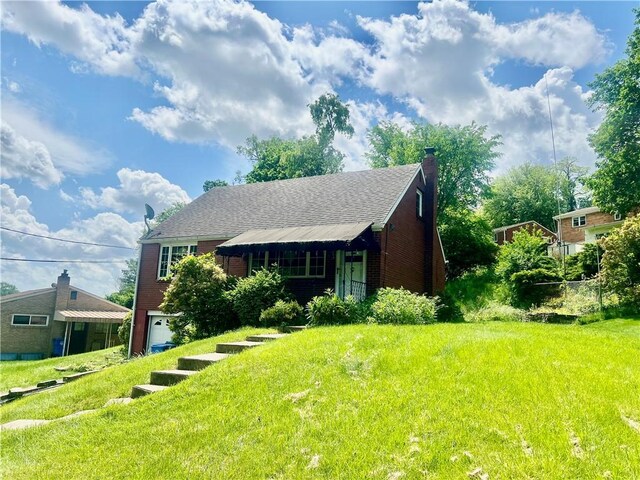 535 Glen Shannon Dr, Castle Shannon, PA 15234 - view of front facade featuring an attached garage, a chimney, a front yard, and brick siding