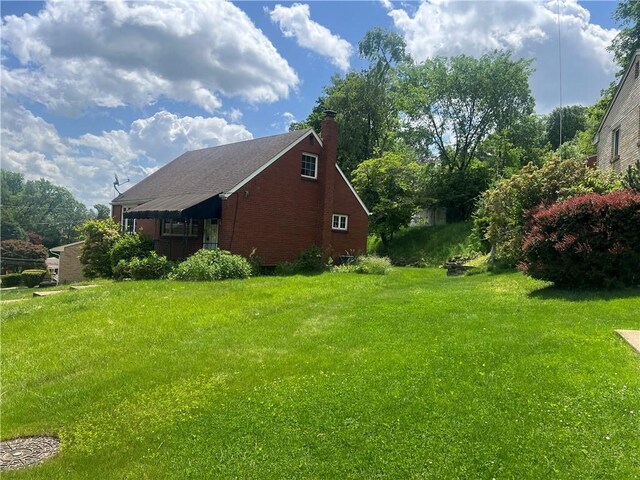 535 Glen Shannon Dr, Castle Shannon, PA 15234 - view of property exterior with a chimney, a lawn, and brick siding