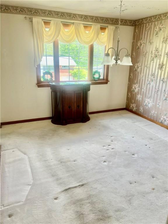 535 Glen Shannon Dr, Castle Shannon, PA 15234 - unfurnished room with plenty of natural light, baseboards, a chandelier, and a dry bar
