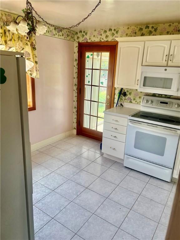 535 Glen Shannon Dr, Castle Shannon, PA 15234 - kitchen featuring white appliances, light tile patterned floors, baseboards, light countertops, and white cabinetry