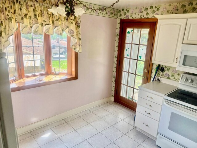 535 Glen Shannon Dr, Castle Shannon, PA 15234 - kitchen with white appliances, baseboards, plenty of natural light, white cabinetry, and wallpapered walls