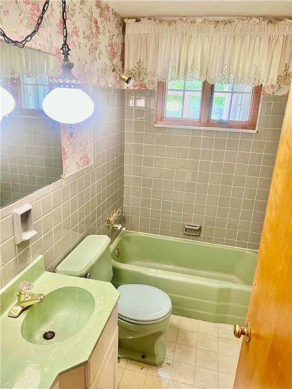 535 Glen Shannon Dr, Castle Shannon, PA 15234 - bathroom featuring tile patterned floors, tile walls, vanity, toilet, and wallpapered walls