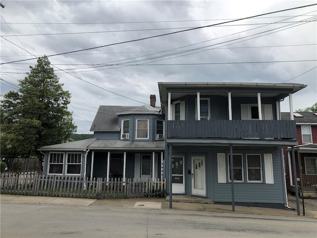 1 S Main St, Fairchance, PA 15437 - view of front of property with a porch, a fenced front yard, and a balcony