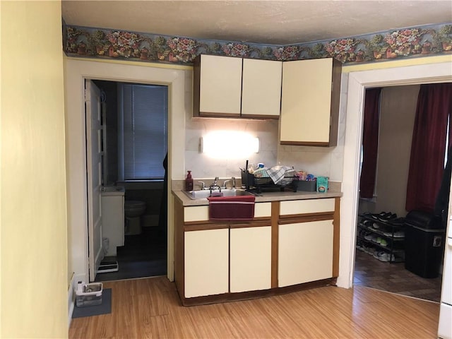 1 S Main St, Fairchance, PA 15437 - kitchen with a sink, light wood-type flooring, and light countertops