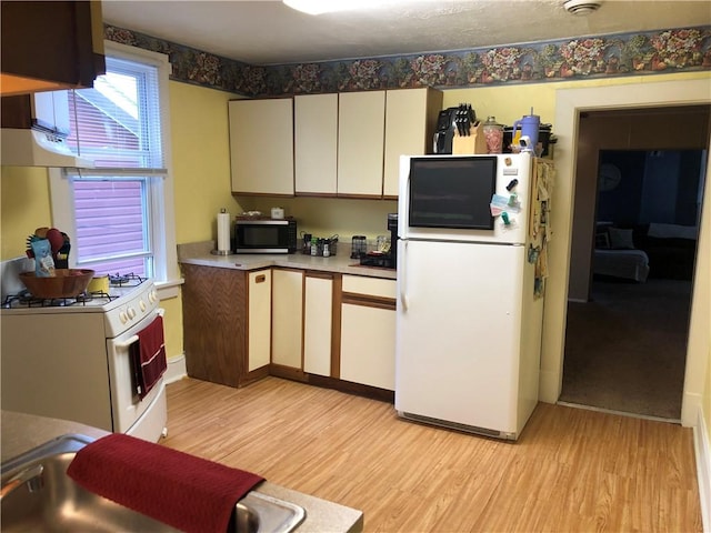 1 S Main St, Fairchance, PA 15437 - kitchen featuring white appliances, light wood-style flooring, and light countertops