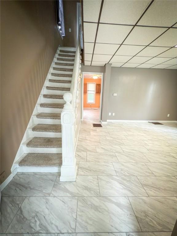 126 W Boyd Ave, City Of But Se, PA 16001 - stairway featuring baseboards, marble look tiles, and a drop ceiling