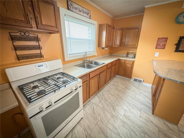 126 W Boyd Ave, City Of But Se, PA 16001 - kitchen featuring white gas range oven, a sink, ornamental molding, light marble finish floors, and brown cabinetry