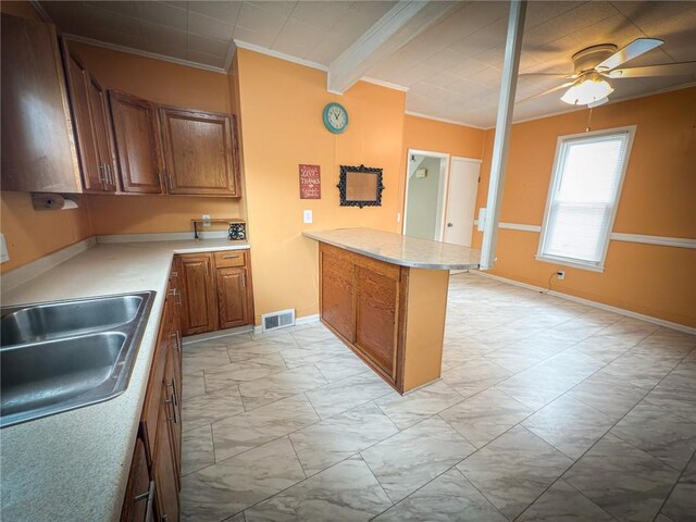 126 W Boyd Ave, City Of But Se, PA 16001 - kitchen with ornamental molding, a peninsula, light marble finish flooring, brown cabinetry, and a sink