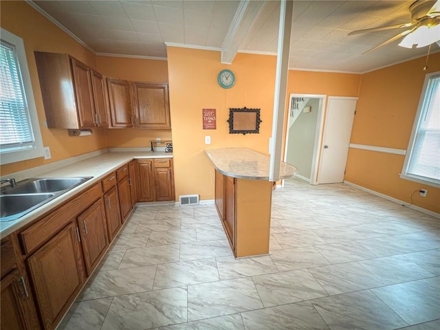 126 W Boyd Ave, City Of But Se, PA 16001 - kitchen featuring a sink, light marble finish flooring, crown molding, brown cabinets, and ceiling fan